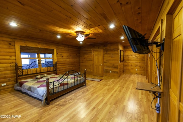 bedroom featuring log walls, light hardwood / wood-style floors, and wooden ceiling