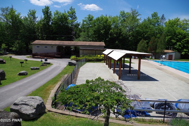 view of swimming pool featuring a storage shed, a gazebo, and a patio