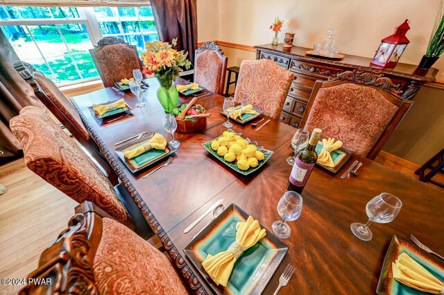 dining space with wood-type flooring