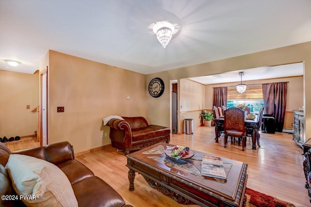 living room featuring light hardwood / wood-style flooring and a notable chandelier