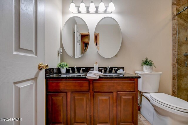 bathroom with walk in shower, tile patterned flooring, vanity, and toilet