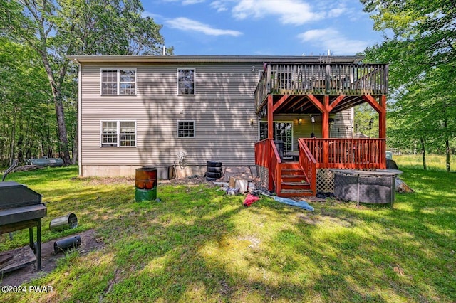 back of property with a deck and a lawn