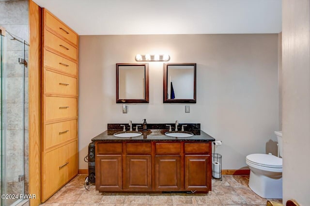 bathroom with vanity, an enclosed shower, and toilet