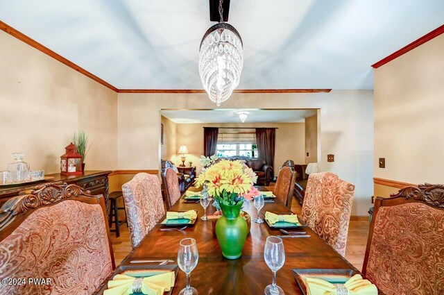 dining room with light wood-type flooring and a chandelier