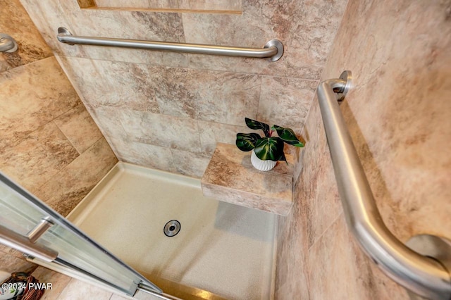 bathroom with tiled shower