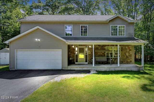 front facade with covered porch and a front yard