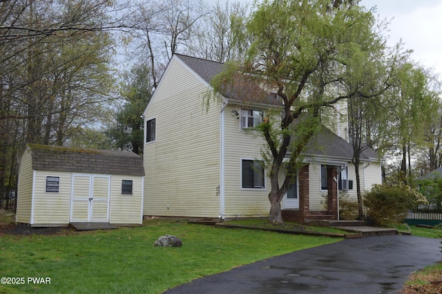 6372 Baltic Ave, Tobyhanna, PA 18466 - view of front of home with a shingled roof, an outbuilding, a storage unit, and a front lawn