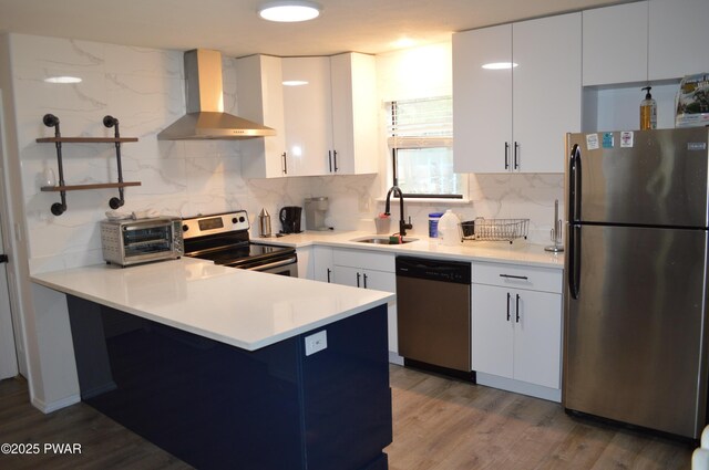 6372 Baltic Ave, Tobyhanna, PA 18466 - kitchen featuring stainless steel appliances, wall chimney exhaust hood, a sink, a peninsula, and tasteful backsplash