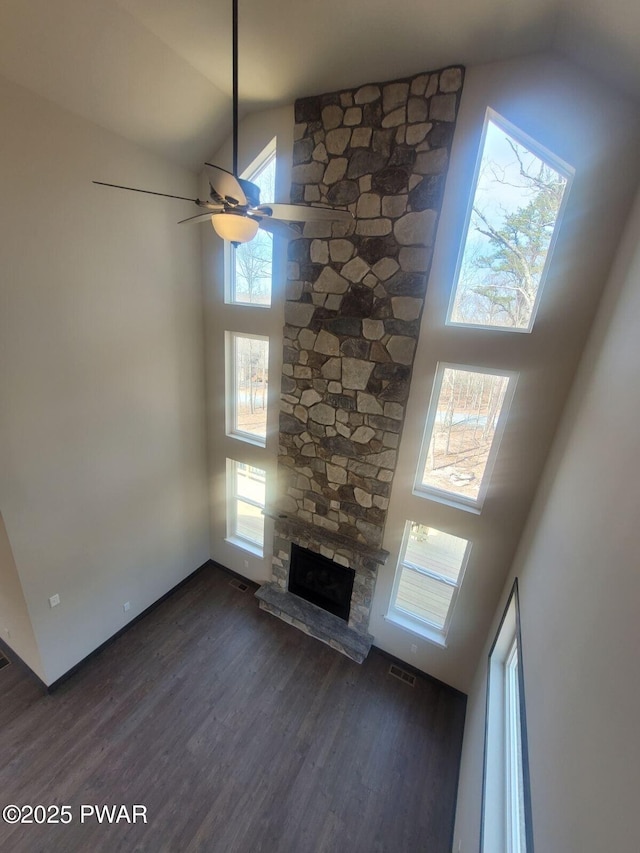 101 Maple Leaf Rd, Lackawaxen, PA 18435 - unfurnished living room with high vaulted ceiling, a ceiling fan, a stone fireplace, and dark wood-type flooring