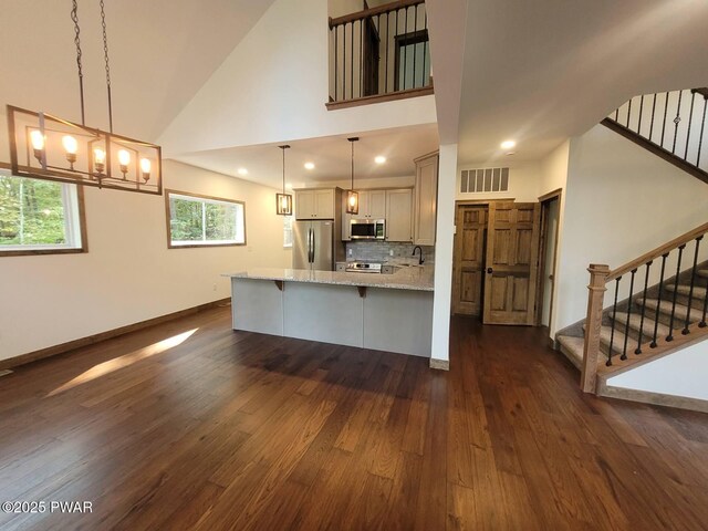 101 Maple Leaf Rd, Lackawaxen, PA 18435 - kitchen with light stone counters, stainless steel appliances, visible vents, a peninsula, and dark wood-type flooring