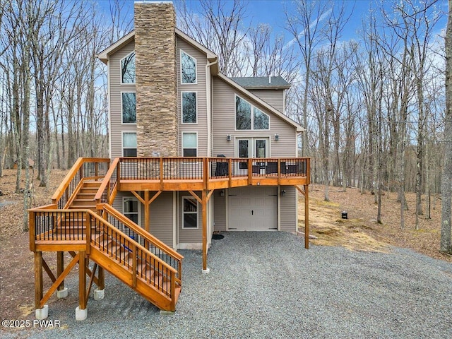 101 Maple Leaf Rd, Lackawaxen, PA 18435 - rear view of house with a chimney, a deck, gravel driveway, a garage, and stairs
