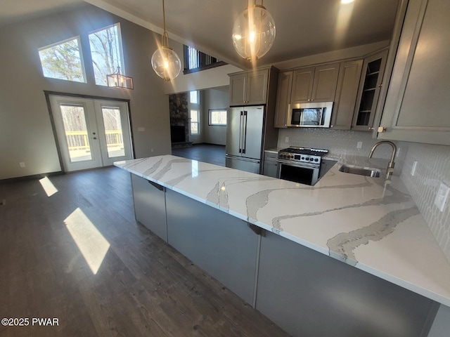 101 Maple Leaf Rd, Lackawaxen, PA 18435 - kitchen with light stone counters, a sink, stainless steel appliances, dark wood-type flooring, and a peninsula