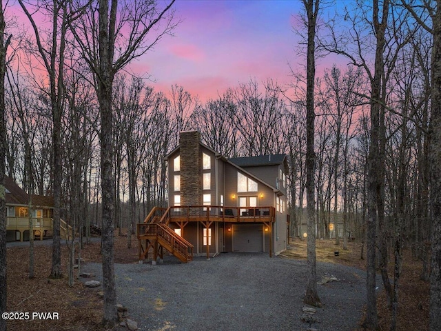 101 Maple Leaf Rd, Lackawaxen, PA 18435 - chalet / cabin with a garage, stairway, driveway, a chimney, and a deck