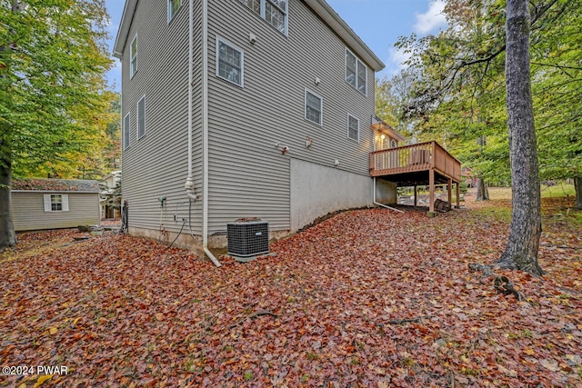 view of property exterior with a wooden deck and central AC unit