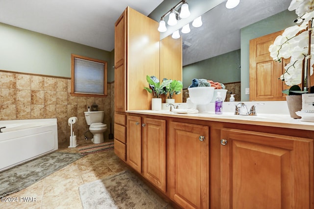 bathroom with vanity, toilet, tile walls, and a tub