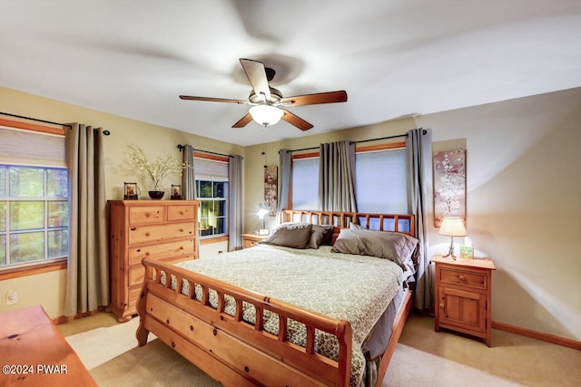 bedroom with ceiling fan and light colored carpet