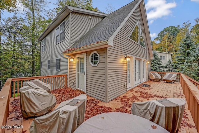 rear view of house with a wooden deck and french doors