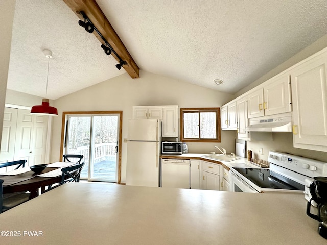 kitchen featuring a sink, under cabinet range hood, white appliances, a textured ceiling, and hanging light fixtures