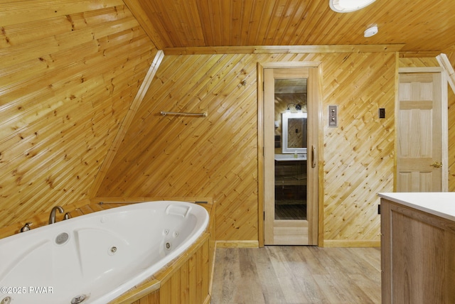 20 Chuck Foster Dr, Hawley, PA 18428 - bathroom featuring wooden walls, wooden ceiling, vanity, a whirlpool tub, and wood finished floors