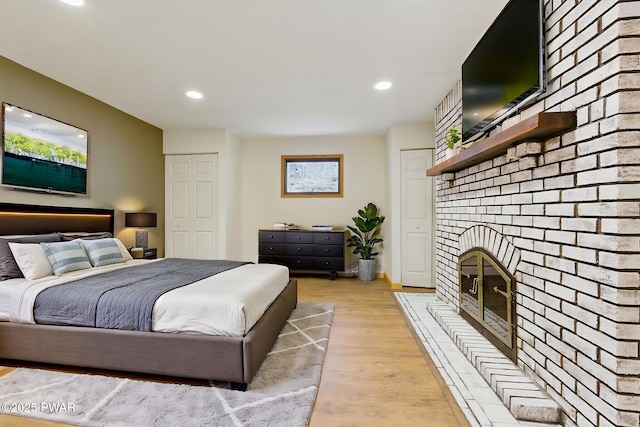 20 Chuck Foster Dr, Hawley, PA 18428 - bedroom featuring light wood-type flooring, a brick fireplace, and recessed lighting