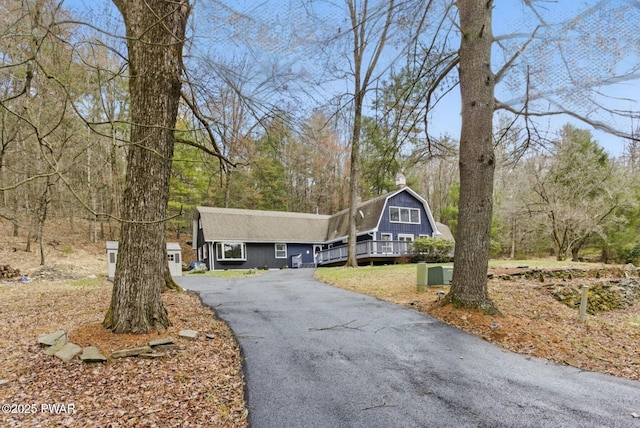 20 Chuck Foster Dr, Hawley, PA 18428 - view of front of house featuring a gambrel roof, asphalt driveway, and a chimney