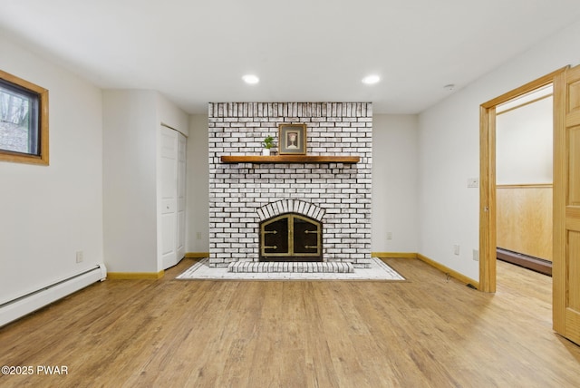 20 Chuck Foster Dr, Hawley, PA 18428 - unfurnished living room with a baseboard radiator, wood finished floors, a fireplace, and recessed lighting