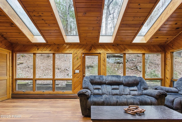 20 Chuck Foster Dr, Hawley, PA 18428 - living area featuring a skylight, lofted ceiling, wood walls, wood ceiling, and baseboard heating