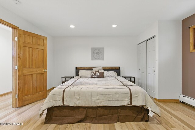 20 Chuck Foster Dr, Hawley, PA 18428 - bedroom featuring light wood-style floors, baseboards, a closet, recessed lighting, and baseboard heating