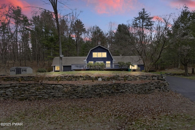 20 Chuck Foster Dr, Hawley, PA 18428 - view of front facade featuring a gambrel roof, an outdoor structure, a shed, and a chimney