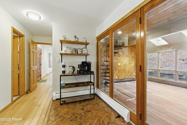 20 Chuck Foster Dr, Hawley, PA 18428 - hallway with a skylight, a baseboard heating unit, an office area, and wooden walls