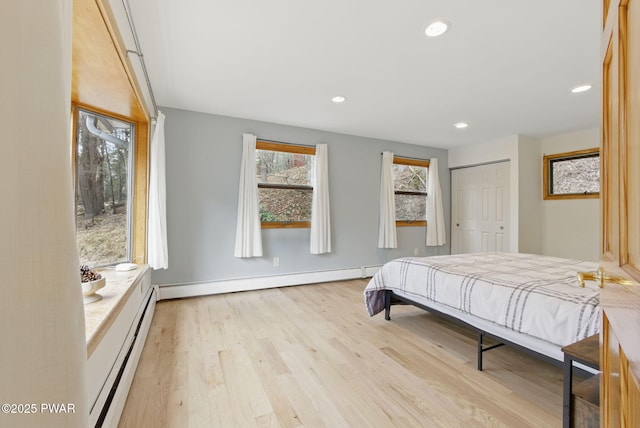20 Chuck Foster Dr, Hawley, PA 18428 - bedroom with baseboard heating, light wood-type flooring, recessed lighting, a closet, and baseboards