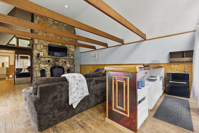 20 Chuck Foster Dr, Hawley, PA 18428 - living room featuring a wainscoted wall, a stone fireplace, light wood finished floors, and wood walls