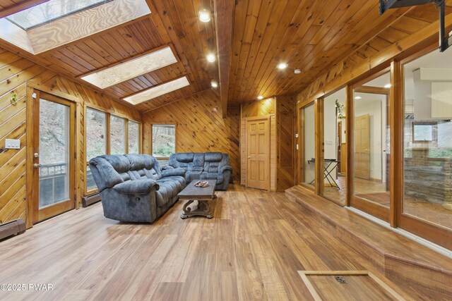20 Chuck Foster Dr, Hawley, PA 18428 - living area featuring a skylight, wooden walls, wooden ceiling, hardwood / wood-style flooring, and a baseboard heating unit