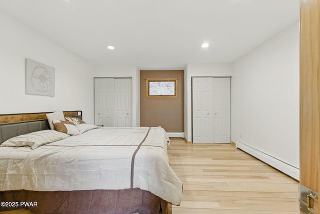20 Chuck Foster Dr, Hawley, PA 18428 - bedroom featuring a baseboard heating unit, two closets, light wood-style floors, recessed lighting, and baseboards
