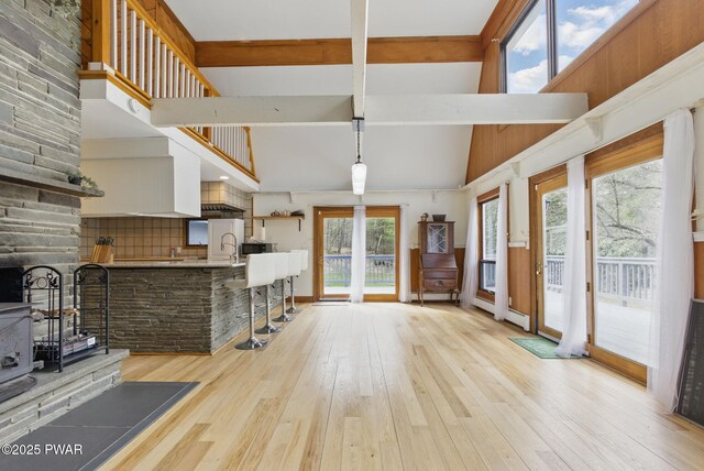 20 Chuck Foster Dr, Hawley, PA 18428 - unfurnished living room with light wood-style flooring, beamed ceiling, and high vaulted ceiling