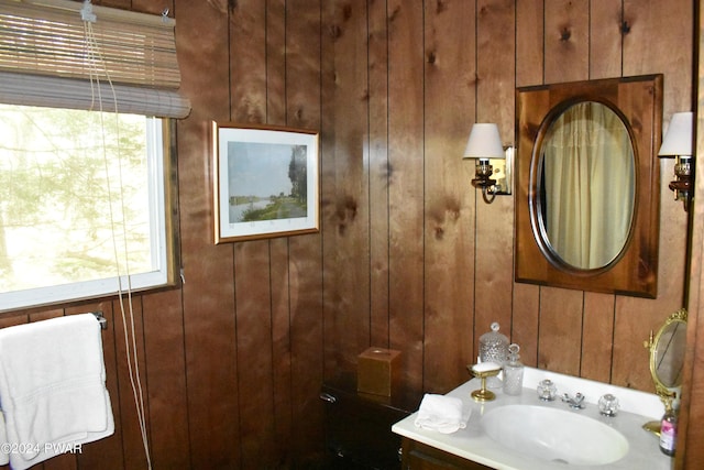 bathroom with wooden walls and vanity