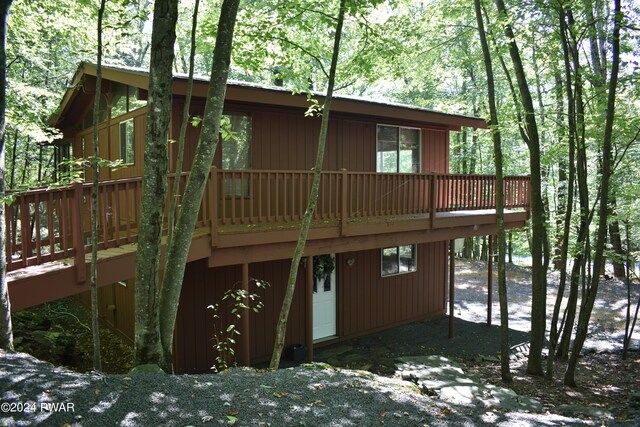 rear view of house featuring a deck