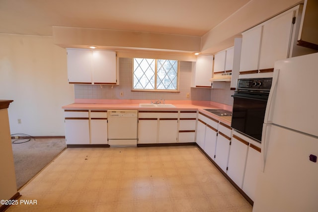 kitchen featuring a sink, backsplash, black appliances, and under cabinet range hood