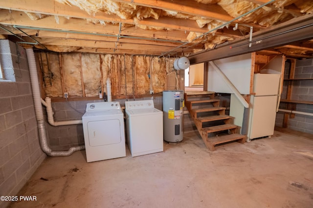 unfinished below grade area with freestanding refrigerator, washer and clothes dryer, stairs, and electric water heater