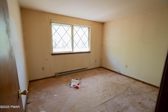 empty room featuring baseboards, a baseboard radiator, and carpet