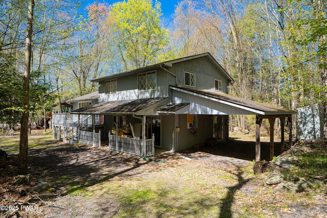 back of property with a porch and a carport
