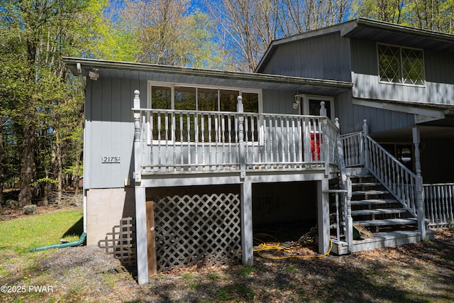 rear view of property with a deck and stairway