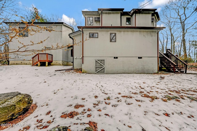 view of snow covered rear of property