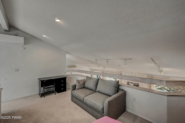 living room with a wall mounted AC, rail lighting, light carpet, and a textured ceiling