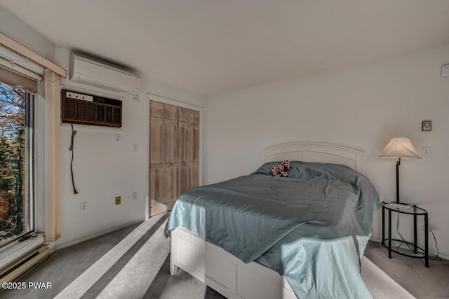 carpeted bedroom with a wall mounted air conditioner and a closet