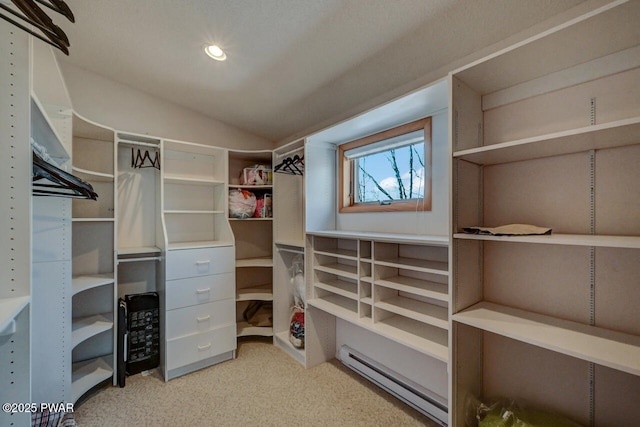 walk in closet featuring lofted ceiling and a baseboard radiator