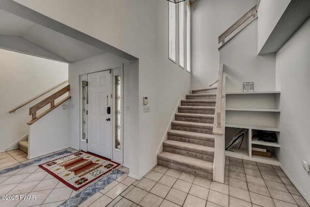 tiled entrance foyer with vaulted ceiling