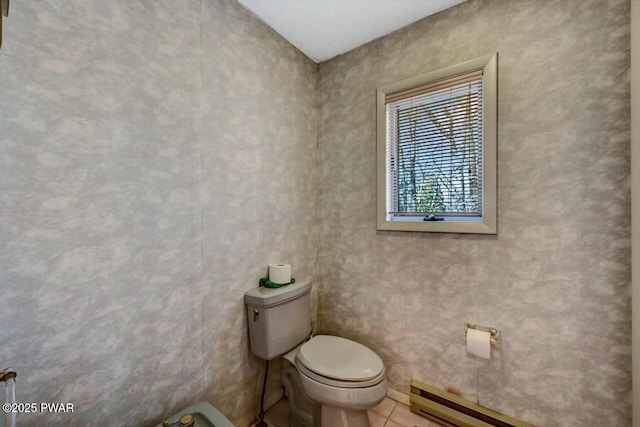 bathroom with tile patterned floors, toilet, and baseboard heating