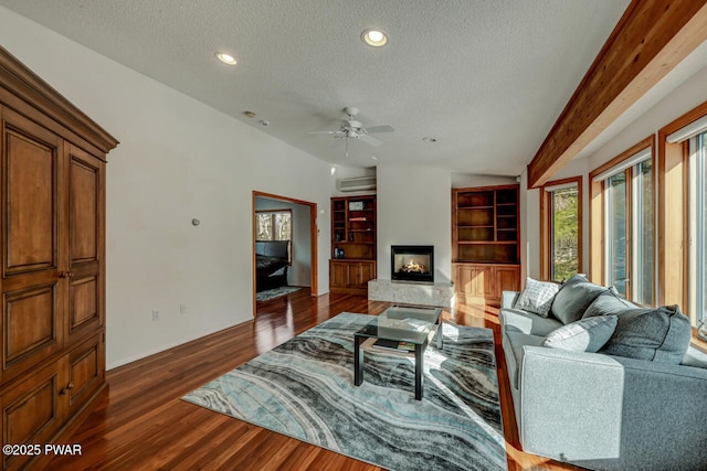 living room featuring lofted ceiling, ceiling fan, a wall unit AC, a textured ceiling, and dark hardwood / wood-style flooring