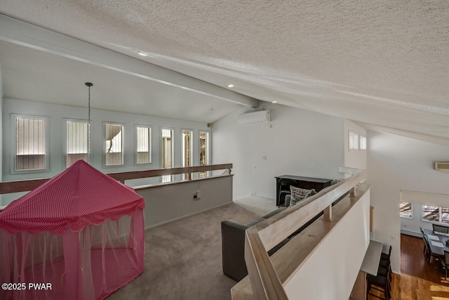 unfurnished living room featuring dark carpet, vaulted ceiling with beams, a textured ceiling, and a wall mounted AC